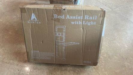 Bed assist railing with motion light and storage pack