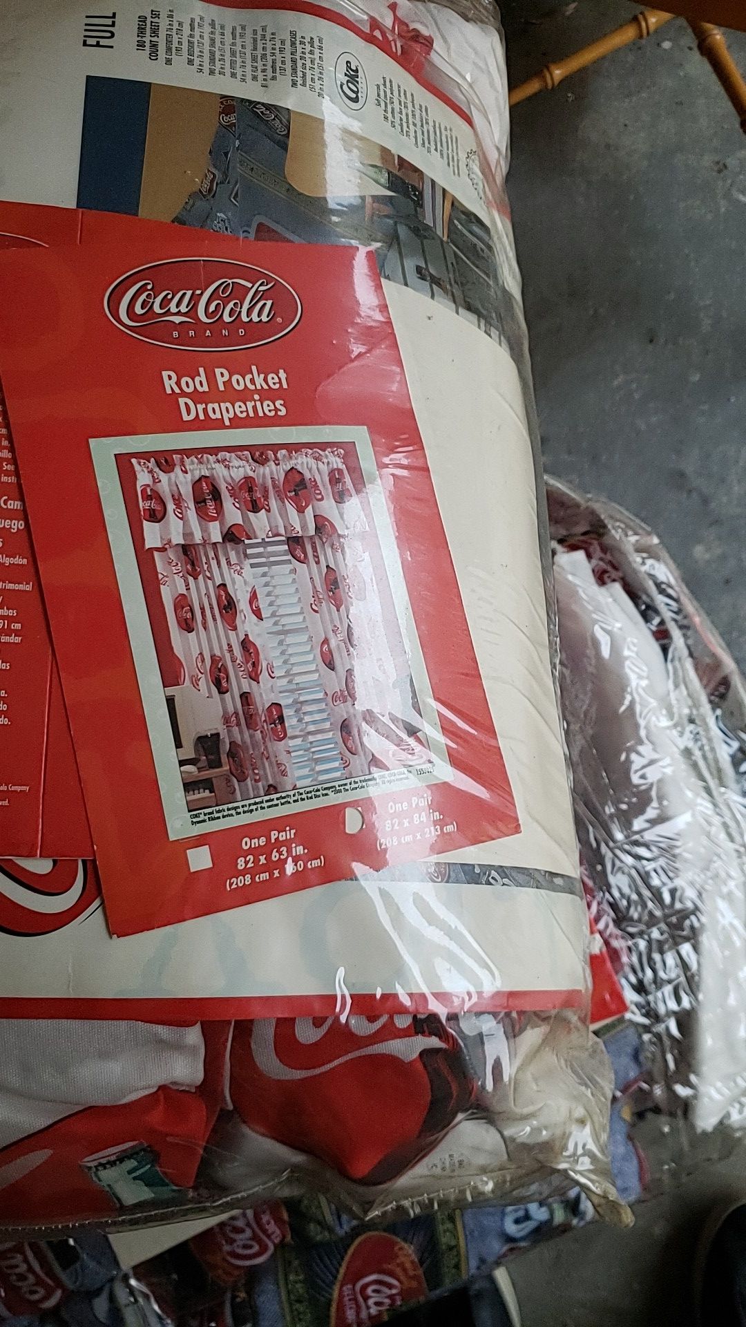 Coca cola comforter. Drapes and ceiling fan