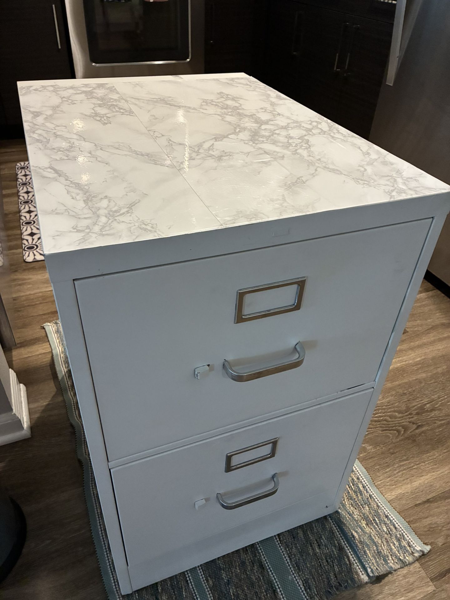 Large White w/tile top FILE CABINET Size: 29”T, 18”W, 25”D. The file jacket is 14”3/4 wide