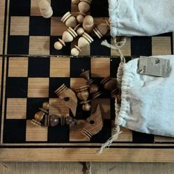 Hand crafted wooden foldable antique style chess board and hand crafted chess pieces equipped with storage pouches
