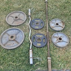 Cap 45lb 2 inch Olympic weight plates, 45lb straight bar, 4x25lb plates, curl bar with flat bench.