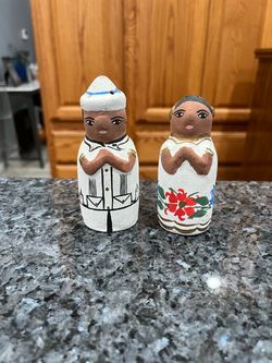 Vintage Clay Folk Art Man and Woman Salt and Pepper Shaker Set.  Size approximately 4 inches tall.  Preowned no stoppers.  Has been on display in a ca