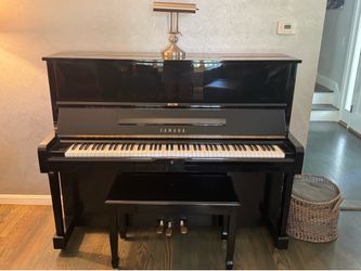 Upright Yamaha piano with bench