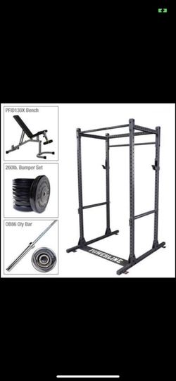 Squat rack with weights and 100 pound adjustable dumbbells