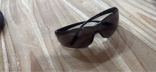 Foster Grant Ironman sport wrap-around sunglasses featuring a black frame with red stripe