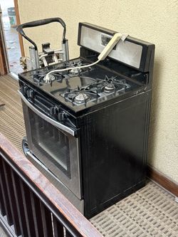 Used gas stove / oven , stainless steel.