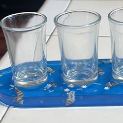 beach-themed shot glass paddle, made of resin. Shot Glasses Are Included.