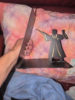 Hallmark Harry Potter metal bookend features a slanted design of the wizard holding a wand.