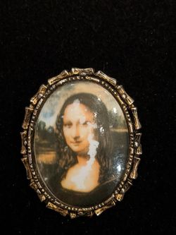 $10. Mona Lisa Brooch. Some peeling. Please see picture. 2 inch long and 1.5 inch wide.