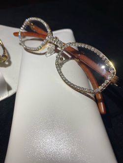 One (1) Millionaire Celebrity French Unisex wooden frame with sparkling lab, diamond ice trim. Comes with a white protective case for secure storage. 