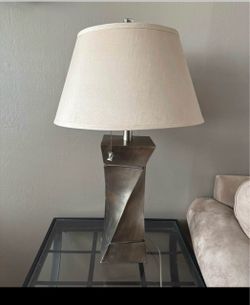 2 Contemporary Table Lamp – Brushed Metal Base  Elevate your space with this stylish table lamp, featuring a distinctive geometric, twisted base in a 