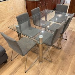 Dinner Table Glass + Fabric Chairs. 