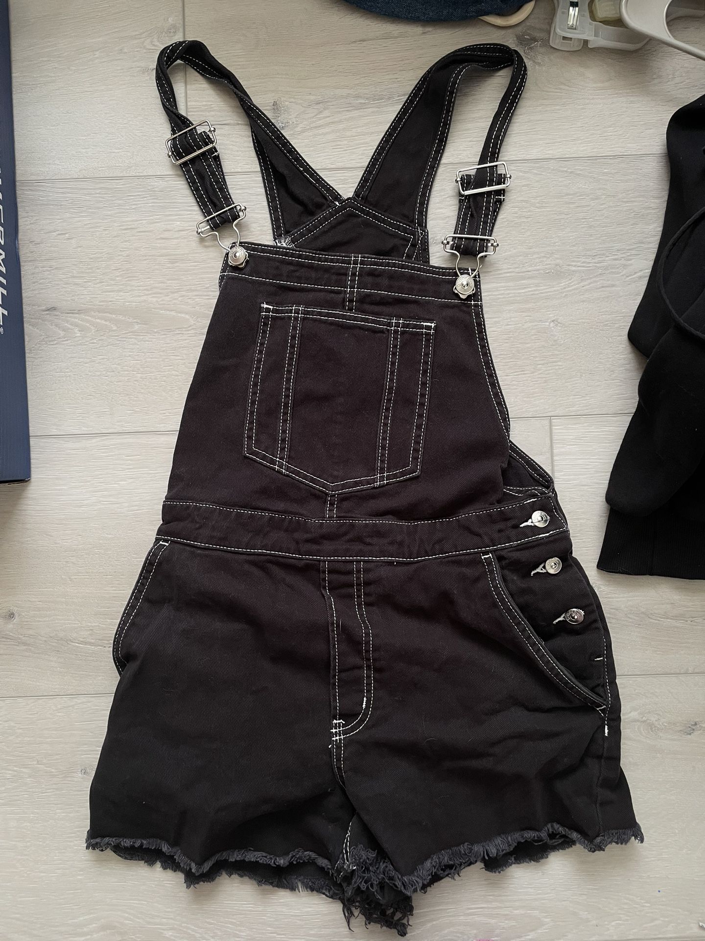 black overalls with white stitching