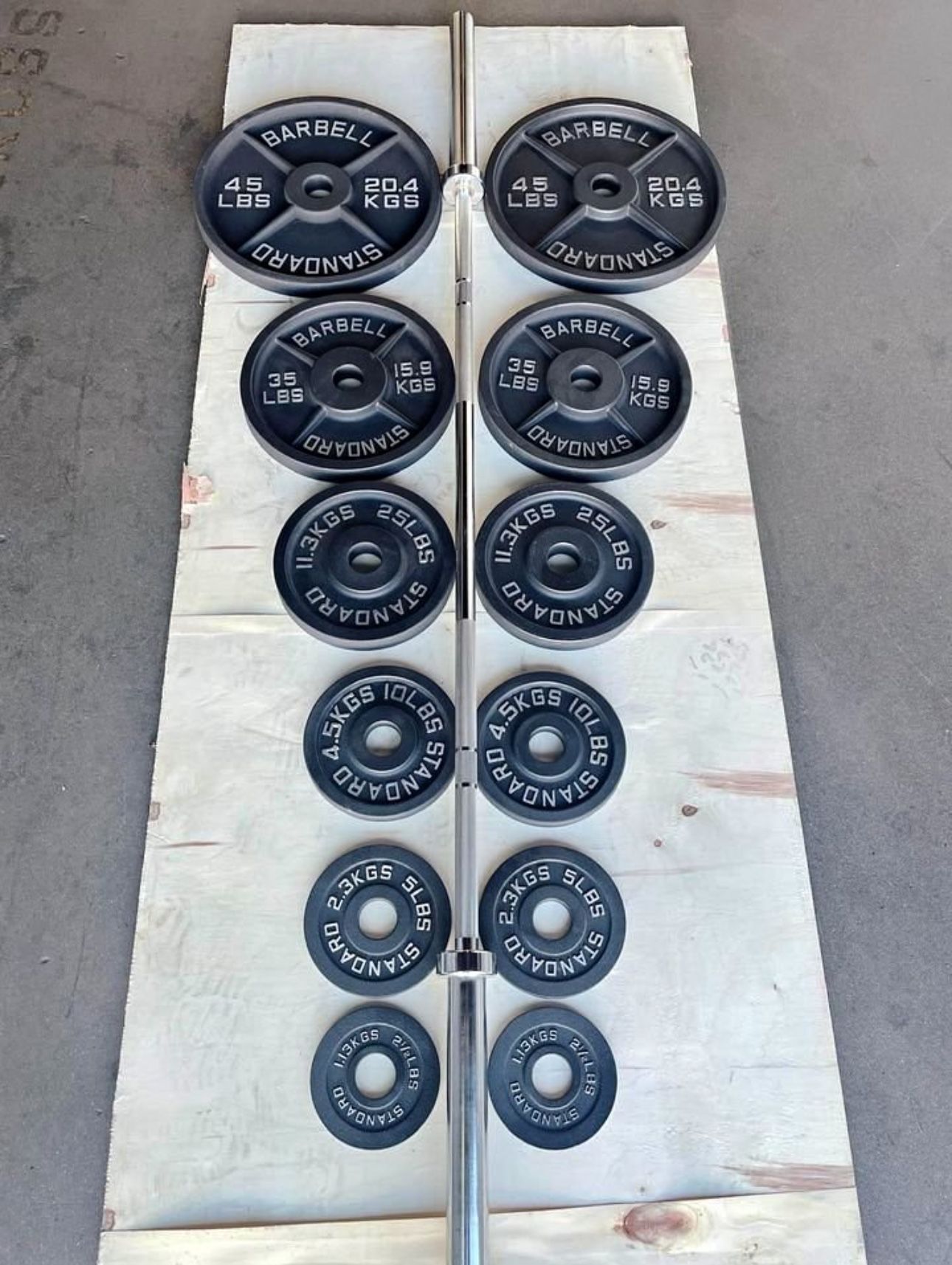Olympic Cast Iron plates set. ( 285 lbs total) brand new in the box . Delivery Available For A Fee