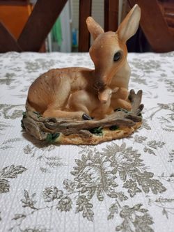 Tender figure of a mother deer with her baby.