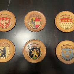 Antique wooden coaster set with German emblems