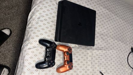 PlayStation 4 Slim Console with Two Controllers