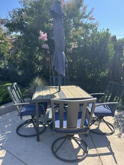 Patio set . Table With Four Chairs And Cushions .