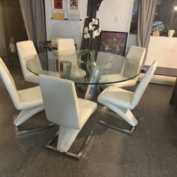 Beautiful Round And Glass Table With Leather Chairs