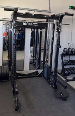 Smith machine squat rack home gym dumbbells kettlebells rubber flooring bench bar leg press weights bumper plates