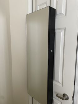 Jewelry Cabinet with mirror and lock.
