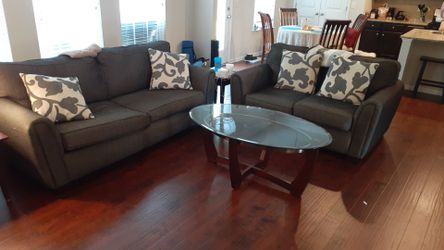 Couch, Love Seat, and Glass coffee table with 4 matching throw pillows