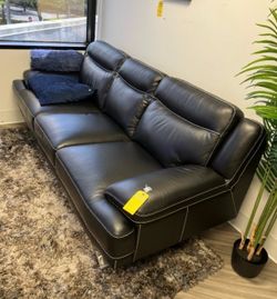Black leather sofa with contrast stitching