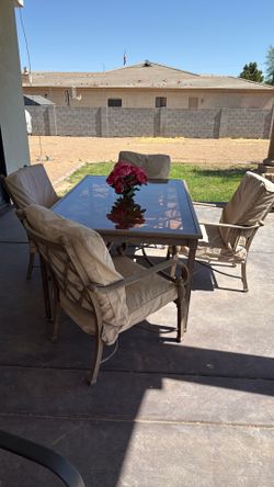 Hampton steel outdoor set. Glass top metal bottom , green cushions with tan tweed scotch guard covers $175 obo