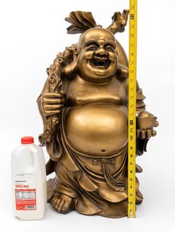 big laugher is a traveling Budai / Hotei — the prosperity Buddha with the fortune bag over the shoulder and an ingot bowl.