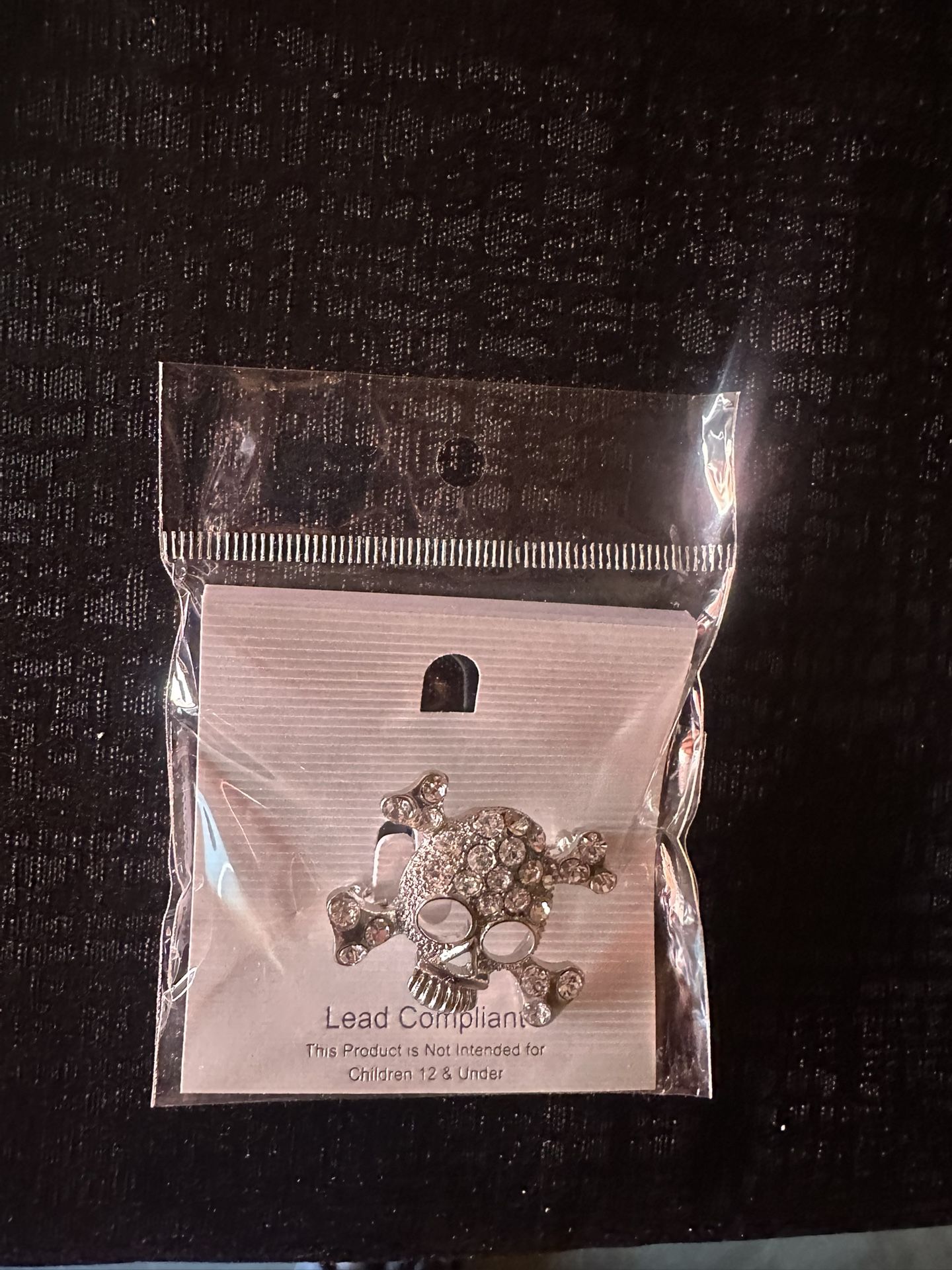 Silver skull brooch