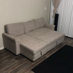 Tan futon with storage compartment