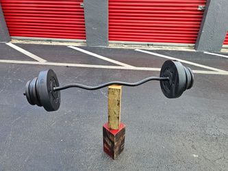💯 pounds aprox EZ Curl Bar with Weight Plates