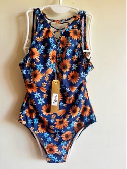 Comfortable one-piece swimsuit with a vibrant navy background and orange floral print. Features a lace-up front for a secure, adjustable fit. Soft, st