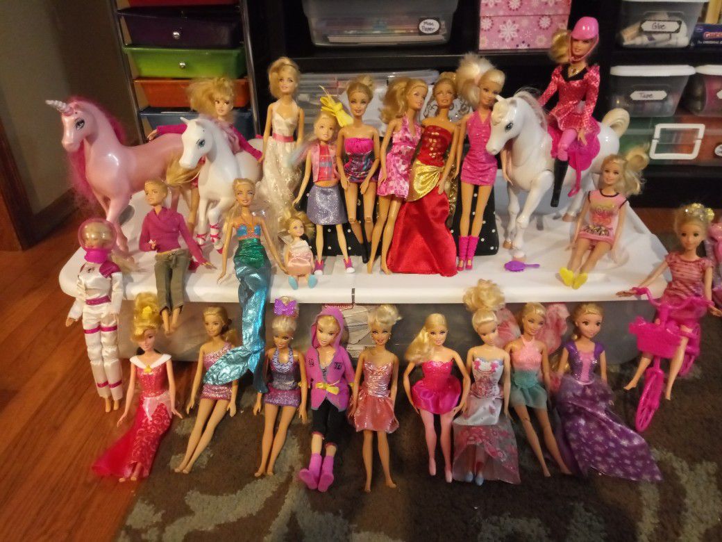 Huge lot of Barbies with cars, horses, clothes and vehicles
