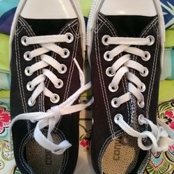 Women's size 7 Converse All Stars low top sneaker. Color is distressed black. Super cute, super cool and in EXCELLENT CONDITION!