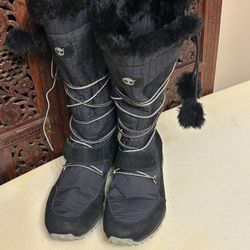 Timberland Boots Womens 8 Black Knee High  Pom Pom Lace Up Winter Snow. Small minor scratch-as I pointed in picture otherwise it’s in great condition