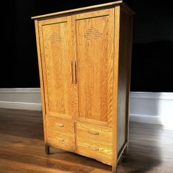 Traditional solid oak clothes wardrobe armoire w/4 drawers. 22 deep by 40 1/2 L by 72H.