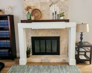 An expandable wooden fireplace surround