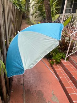 light blue and white striped  beach umbrella