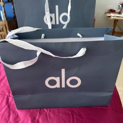 2 Alo sportswear bags w one merchandise tag for yoga attire.  beautiful condition in their grayish blue color and white cloth carrying handles