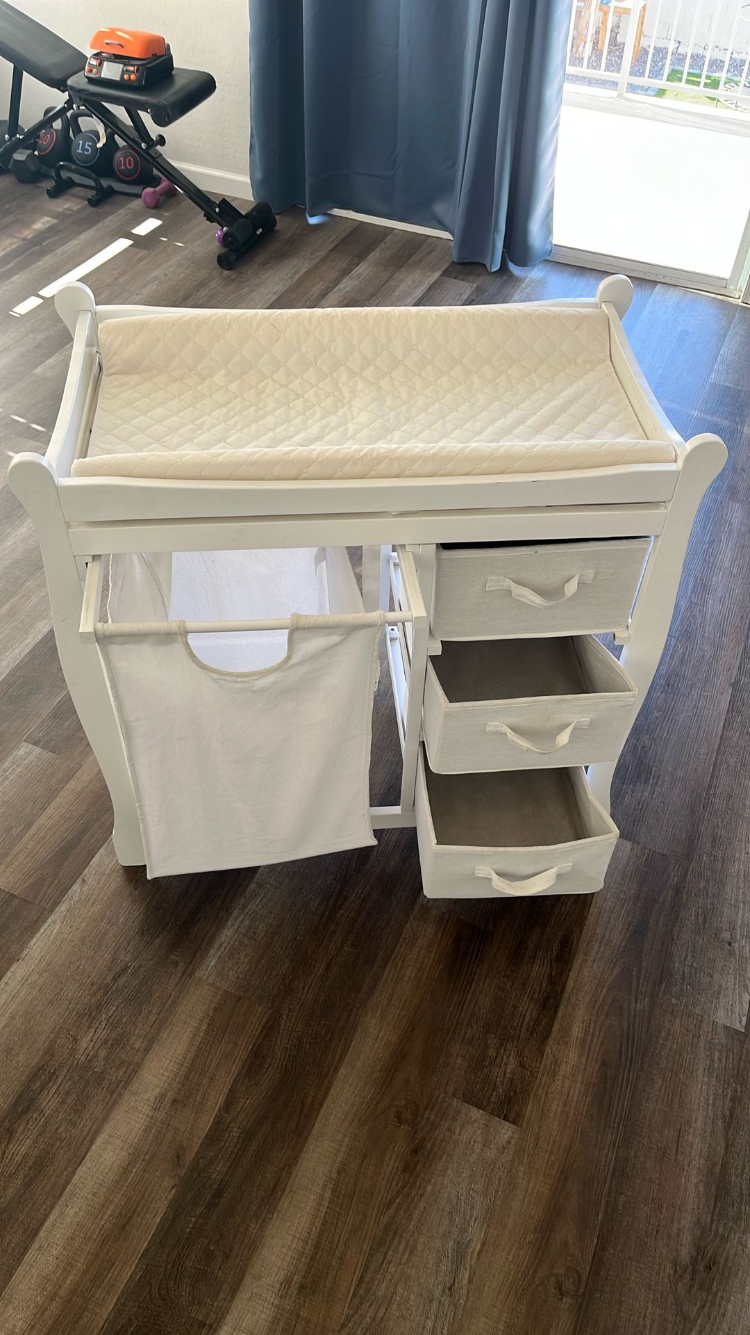 Baby changing table with hamper and three drawers. $50 OBO