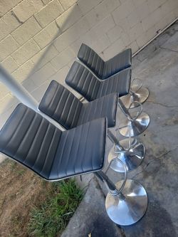 Set of 4 grey barstool set little ware on them  adjustable height with foot rest in good working condition