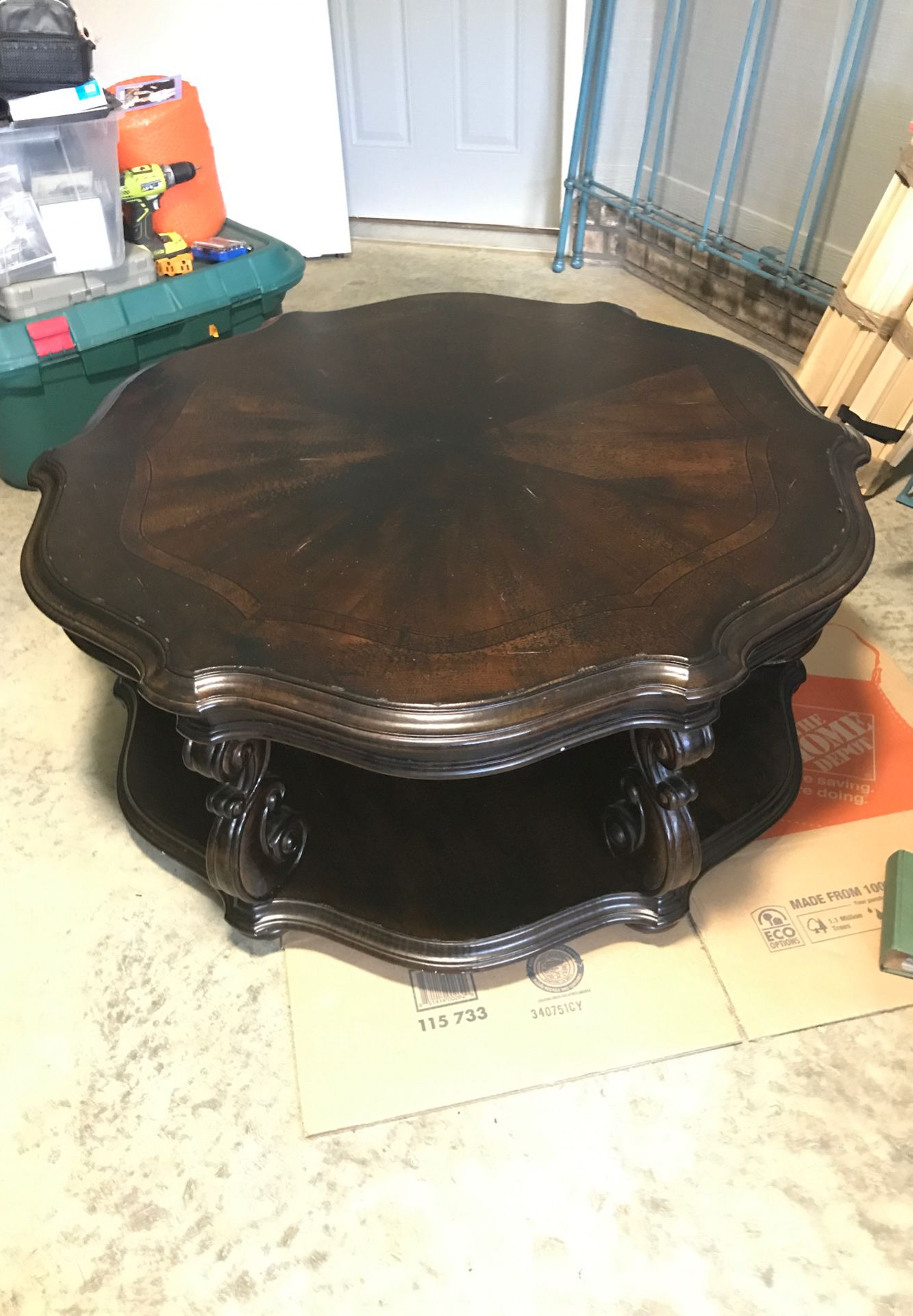 Round cocktail table, black distressed with brown undertones. In great condition.
