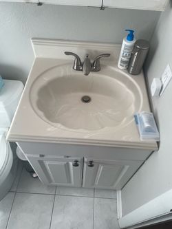 Free 24” Bathroom vanity with sink and triple mirror medicine cabinet.