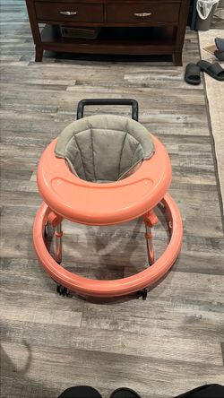 Foldable pink and grey baby walker with 6 height adjustments
