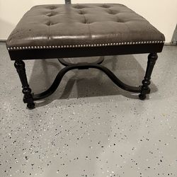 Grey and black leather ottoman