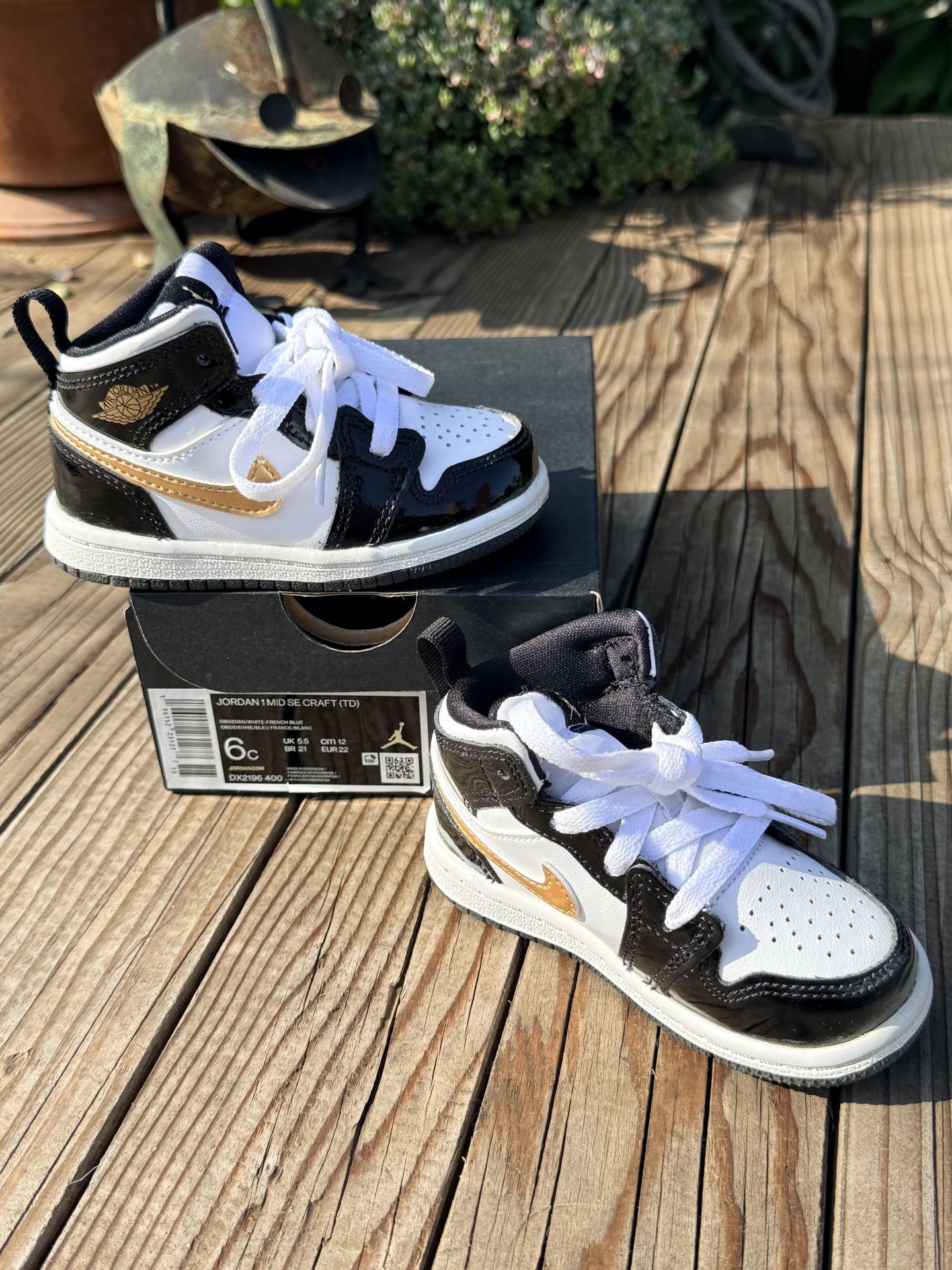 Jordan kids black and white sneakers w/gold accents