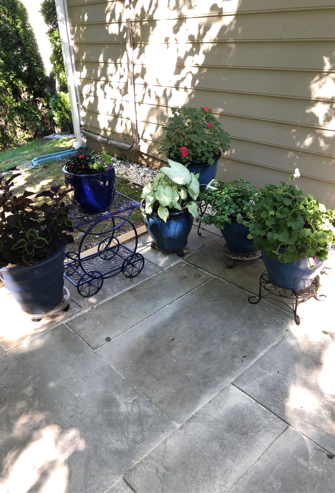 6 outdoor blue planters and one blue outdoor table