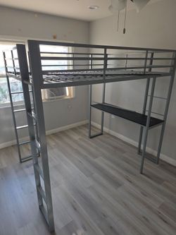 Bed with bottom desk.