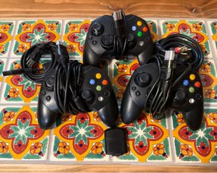 Three original Xbox controllers, AV cable, power cable and memory card